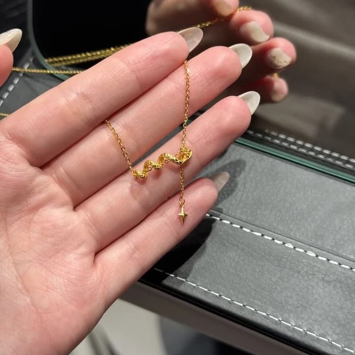 ゴールドアクセサリー うねる蛇と星のしずくネックレス